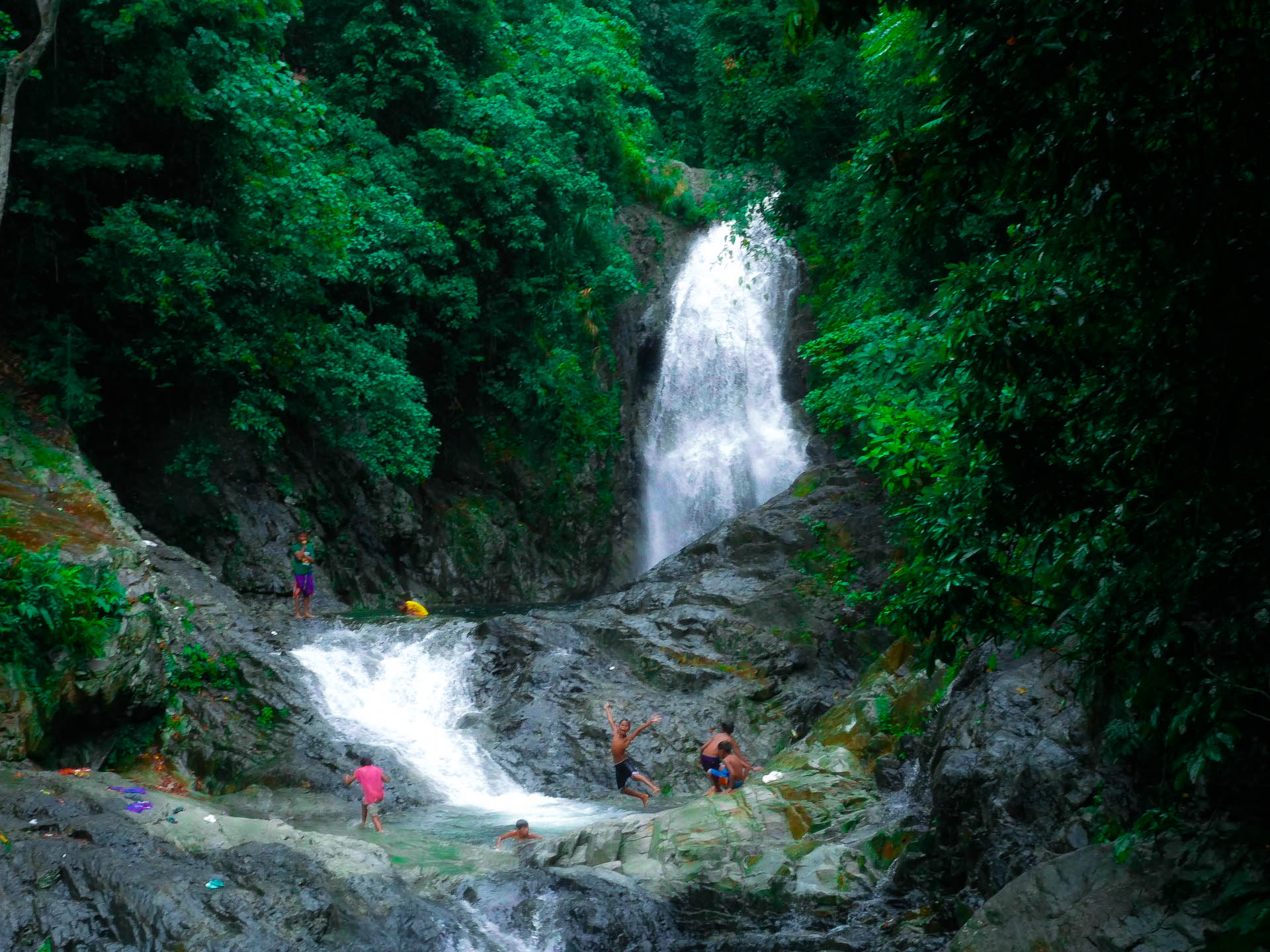filipino kids playing at hicming falls in catanduanes philippines
